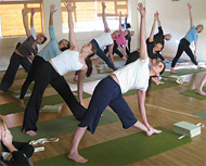 A class in a standing pose in a hall